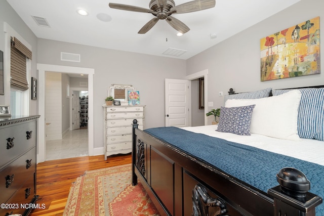 bedroom with light hardwood / wood-style floors and ceiling fan