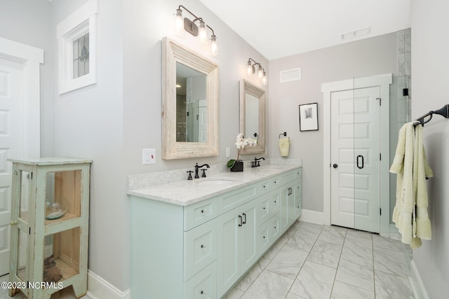 bathroom with vanity and a shower with shower door