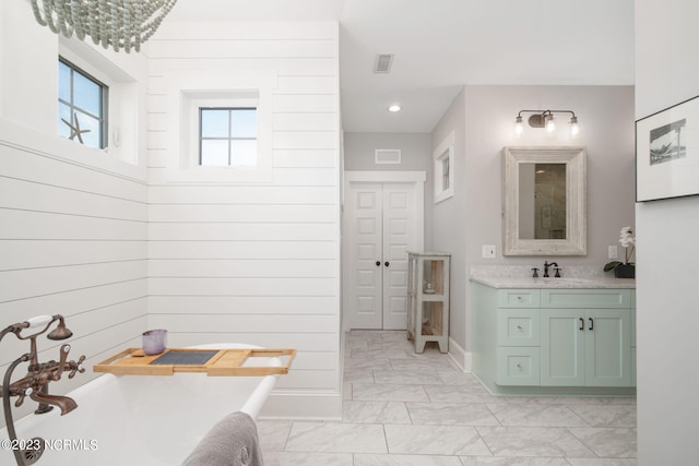 bathroom featuring vanity, a notable chandelier, and wooden walls