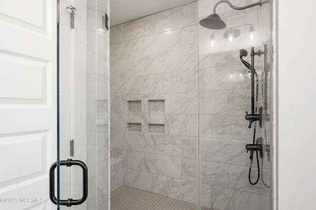 bathroom with a shower with shower door