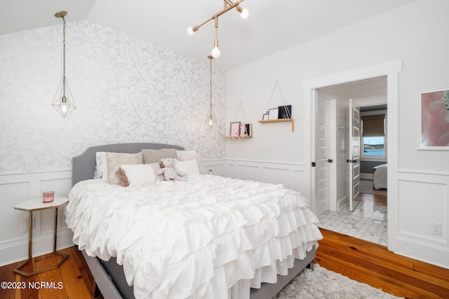 bedroom featuring vaulted ceiling and hardwood / wood-style flooring