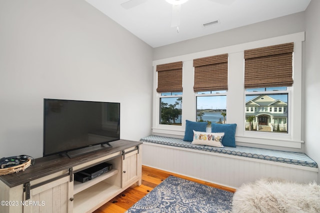 sitting room with ceiling fan and light hardwood / wood-style flooring