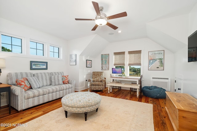 living room with a healthy amount of sunlight, ceiling fan, hardwood / wood-style flooring, and vaulted ceiling