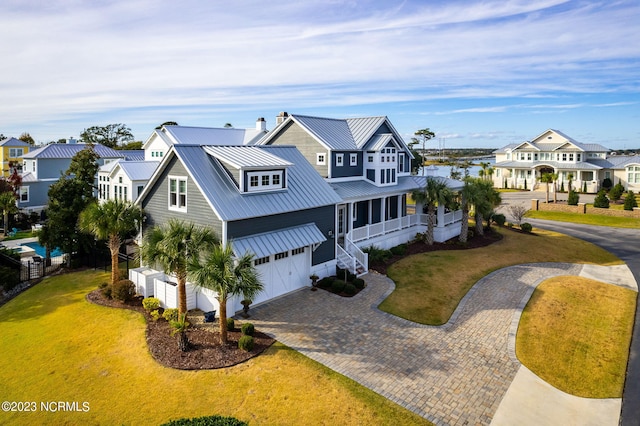 view of front of home with a front lawn and a garage