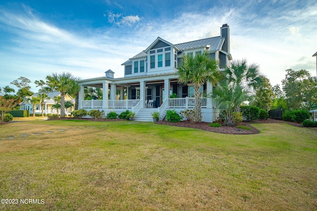 view of front of home with a front yard and a porch