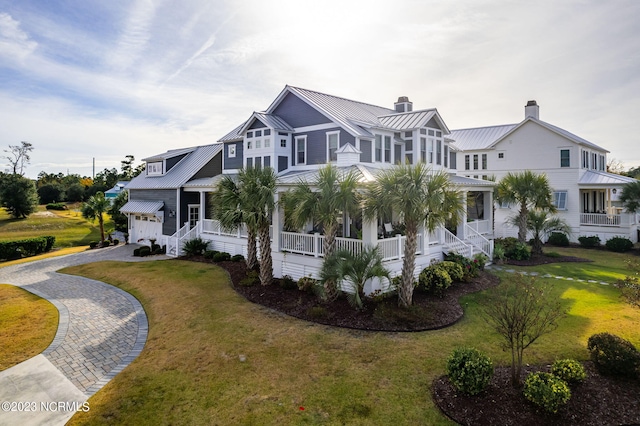 view of front of home with a front yard and covered porch