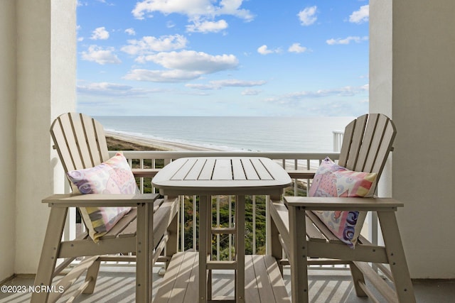 balcony featuring a water view and a view of the beach