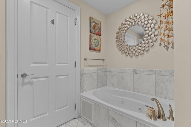 bathroom with tile flooring and tiled tub