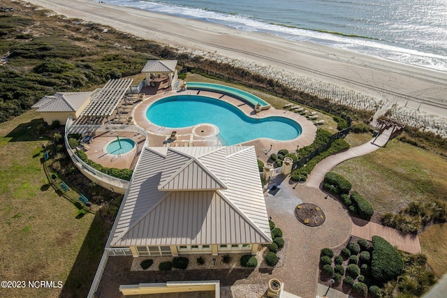 bird's eye view featuring a water view and a view of the beach