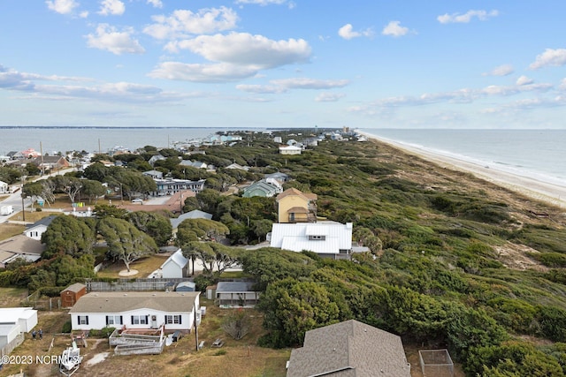 birds eye view of property with a water view and a view of the beach