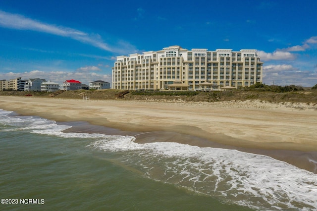 exterior space with a water view and a view of the beach