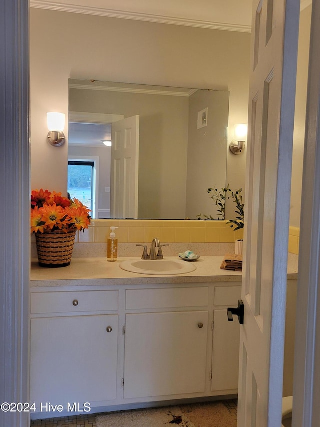 bathroom with vanity and crown molding