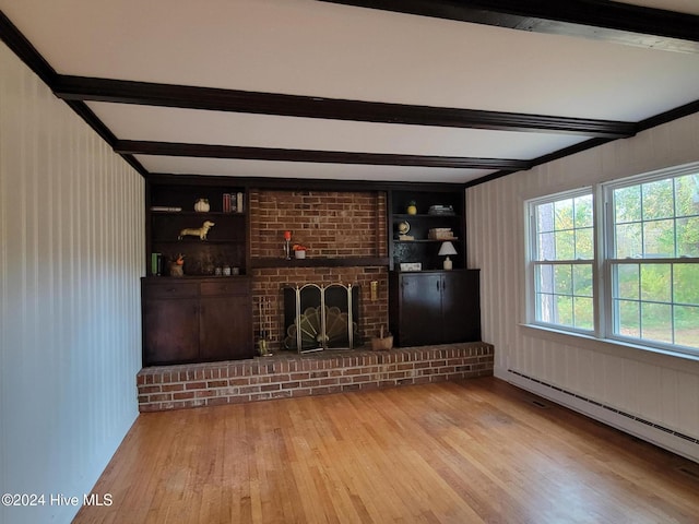 unfurnished living room featuring a brick fireplace, light hardwood / wood-style floors, built in features, a baseboard radiator, and beam ceiling