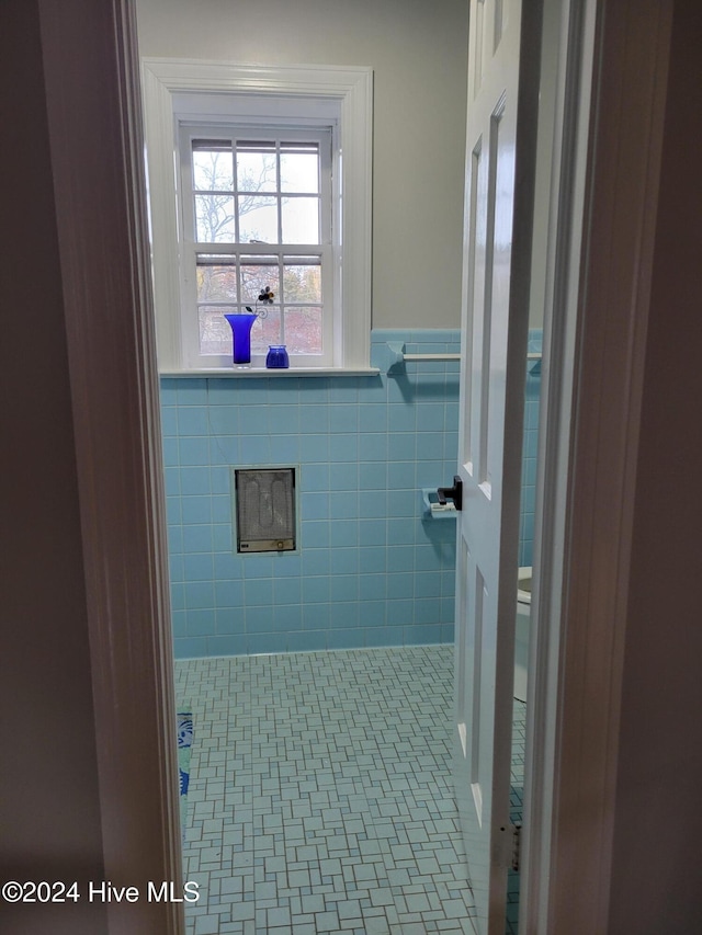 bathroom with tile walls