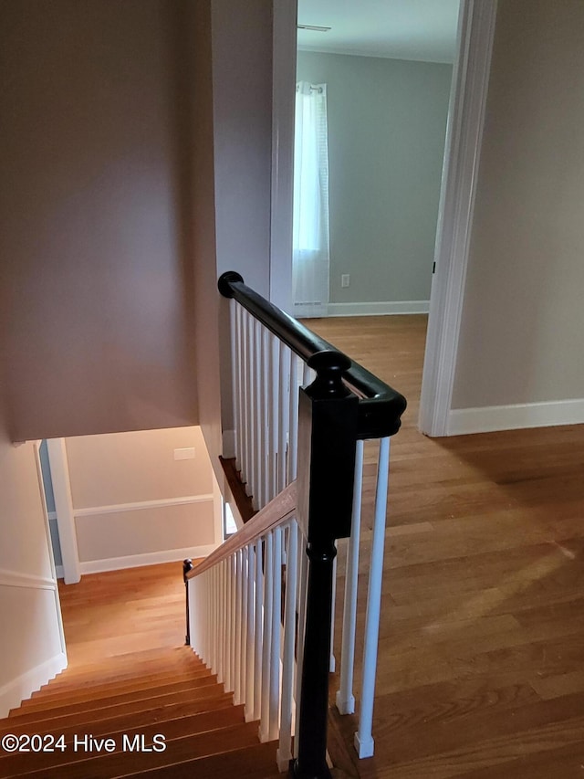 stairs with wood-type flooring