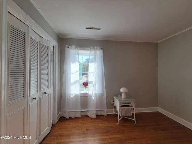 interior space with wood-type flooring and ornamental molding