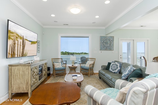 living room with light hardwood / wood-style flooring and ornamental molding