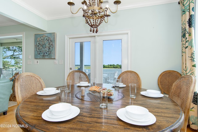 dining room with a healthy amount of sunlight, crown molding, and a chandelier