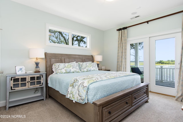 bedroom featuring light colored carpet, multiple windows, and access to outside