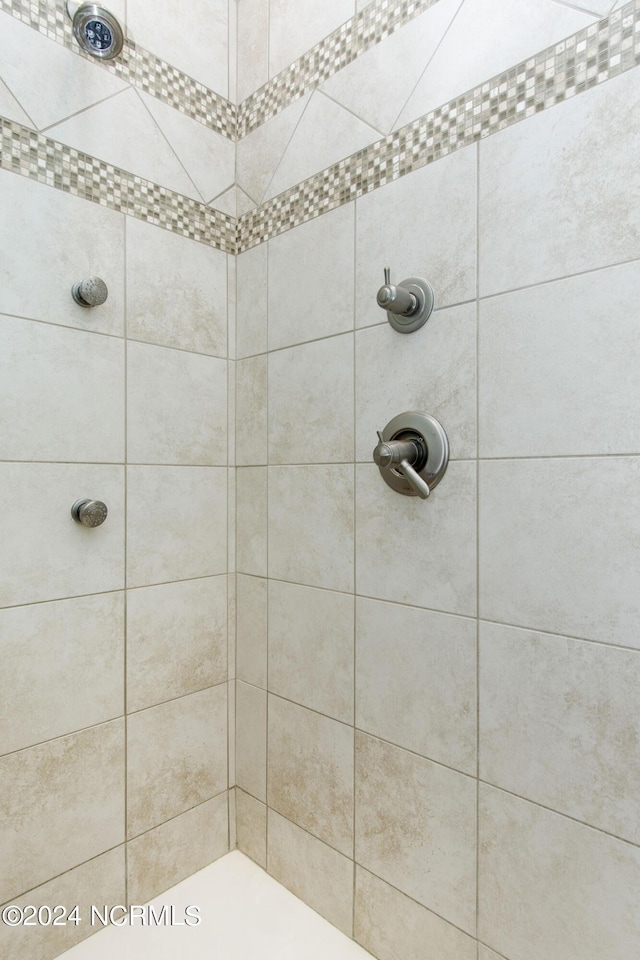 bathroom with a tile shower