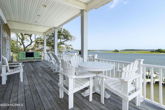 wooden terrace featuring a water view