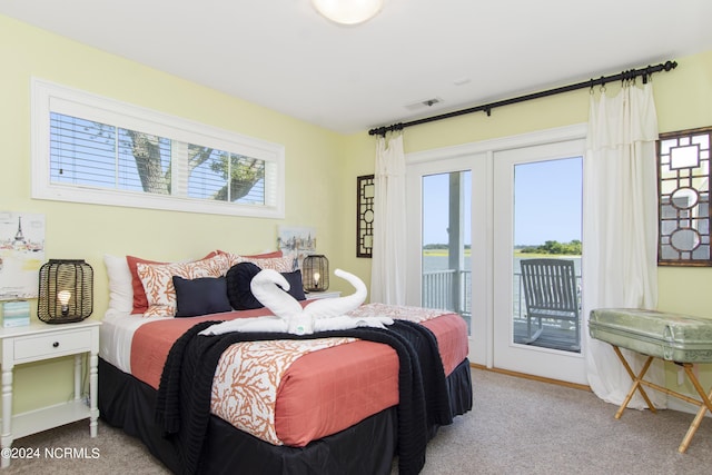 bedroom featuring light carpet and access to outside