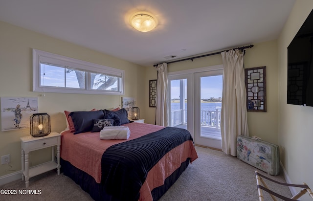 bedroom featuring access to outside and light colored carpet