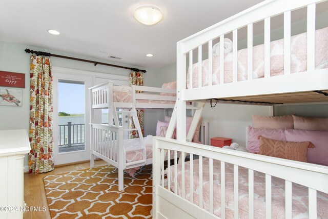 bedroom featuring wood-type flooring and access to exterior