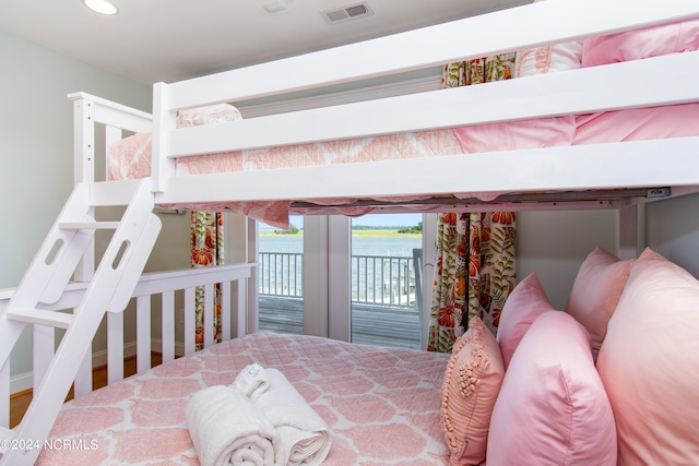 bedroom featuring hardwood / wood-style flooring and access to outside