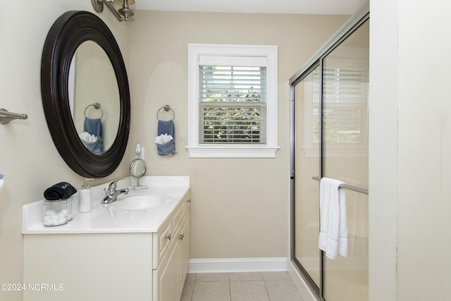 bathroom featuring vanity, tile patterned flooring, and walk in shower