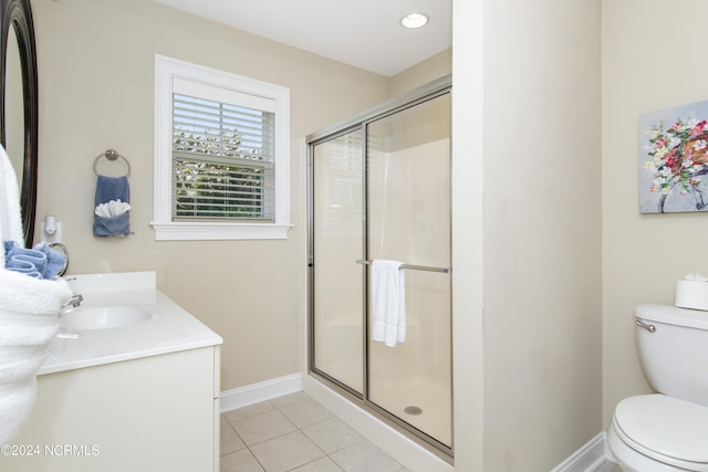 bathroom with tile patterned floors, toilet, a shower with shower door, and vanity