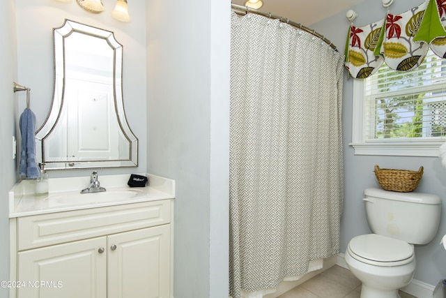 bathroom featuring vanity, toilet, and tile patterned flooring