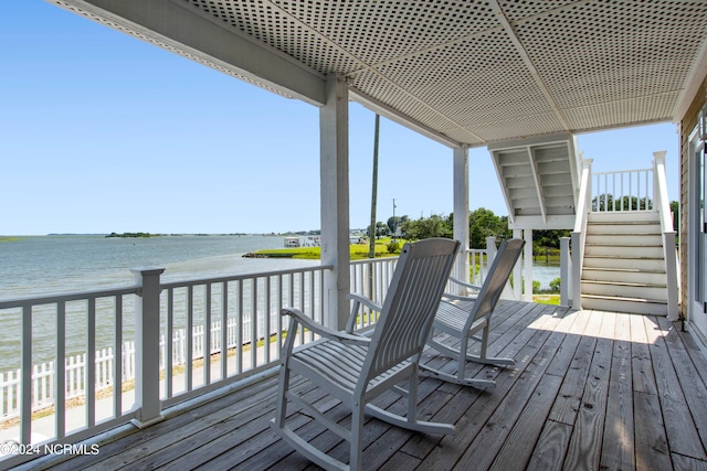 wooden terrace featuring a water view