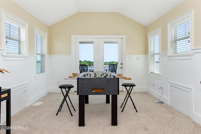 game room featuring lofted ceiling and light colored carpet