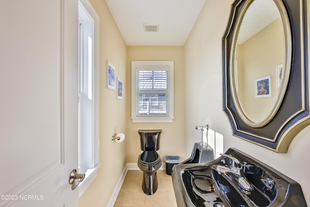 bathroom with tile patterned floors and toilet