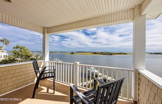 exterior space with a balcony and a water view