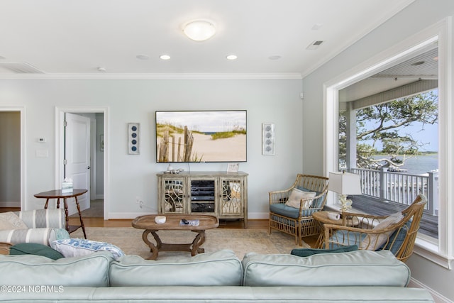 living room with ornamental molding and hardwood / wood-style floors