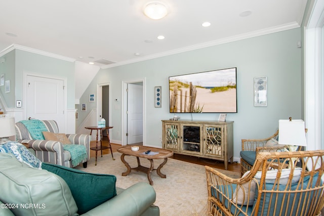 living room featuring ornamental molding and wood-type flooring