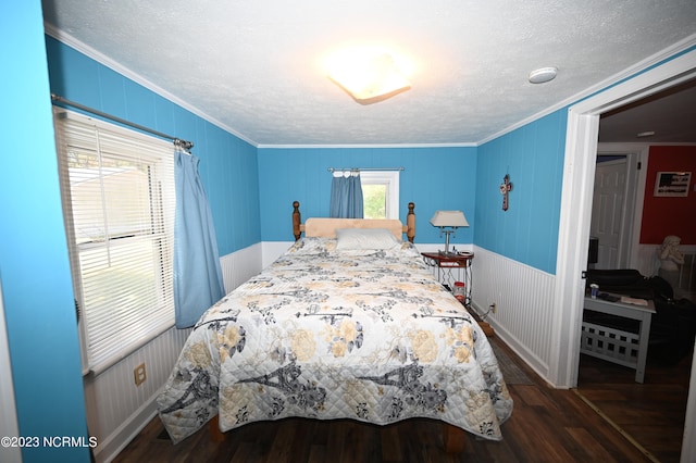 bedroom featuring a textured ceiling, ornamental molding, and dark hardwood / wood-style flooring