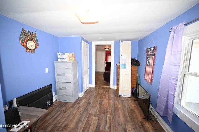 unfurnished bedroom with dark wood-type flooring