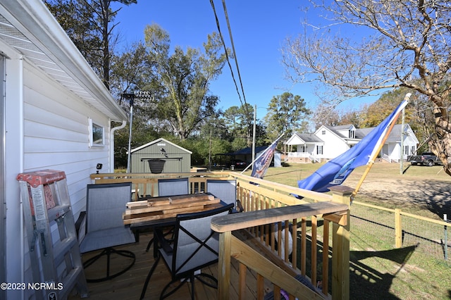 wooden terrace with a yard and a shed