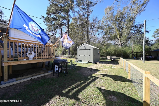 view of yard featuring a storage unit and a deck