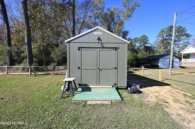 view of outdoor structure with a lawn