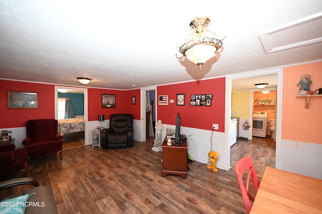 living room with dark hardwood / wood-style floors, ornamental molding, and a textured ceiling