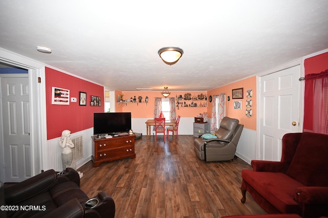 living room with a textured ceiling and dark hardwood / wood-style floors