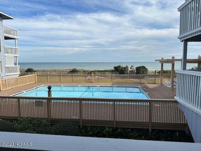 view of pool with a deck with water view