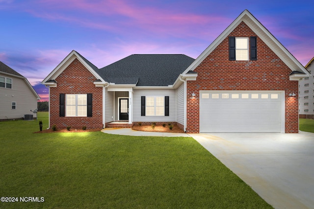 view of front of home featuring a garage, central air condition unit, and a lawn