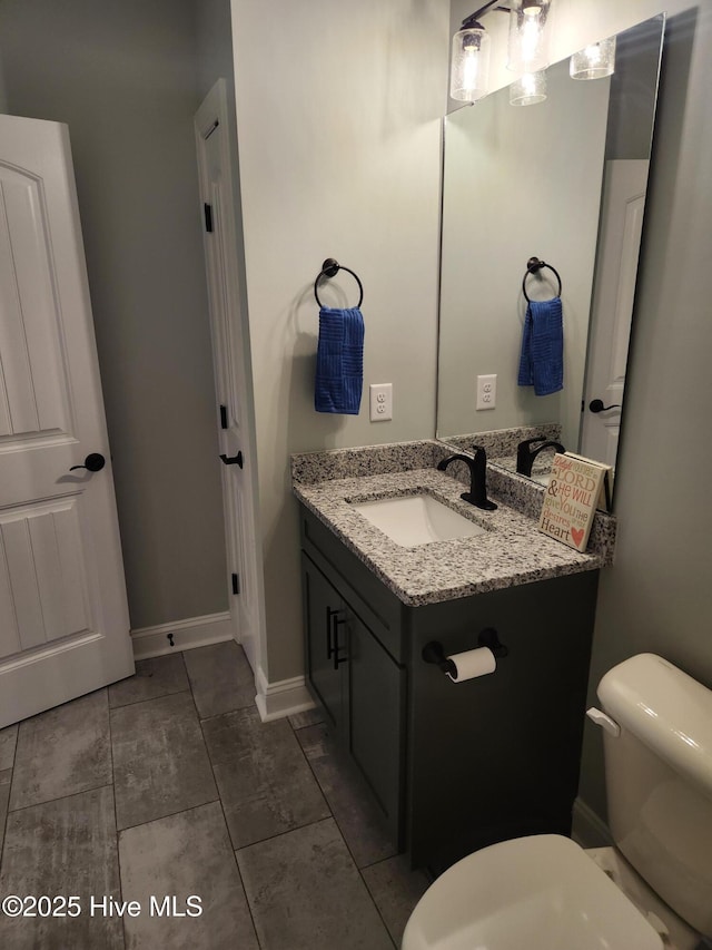 bathroom featuring tile patterned floors, vanity, and toilet