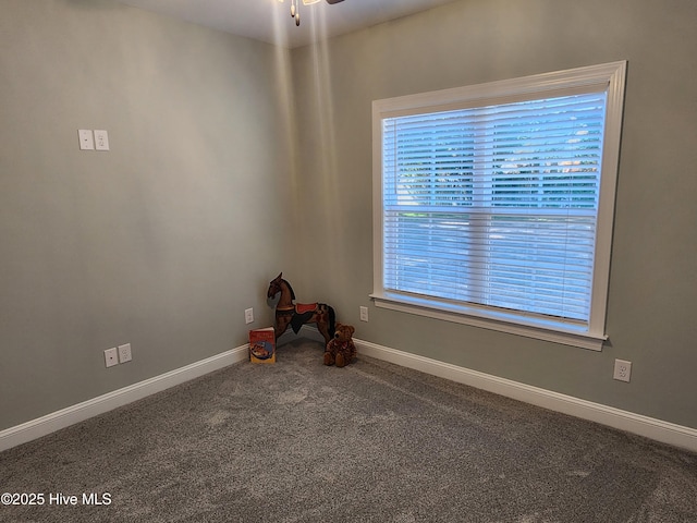 carpeted empty room featuring plenty of natural light and ceiling fan