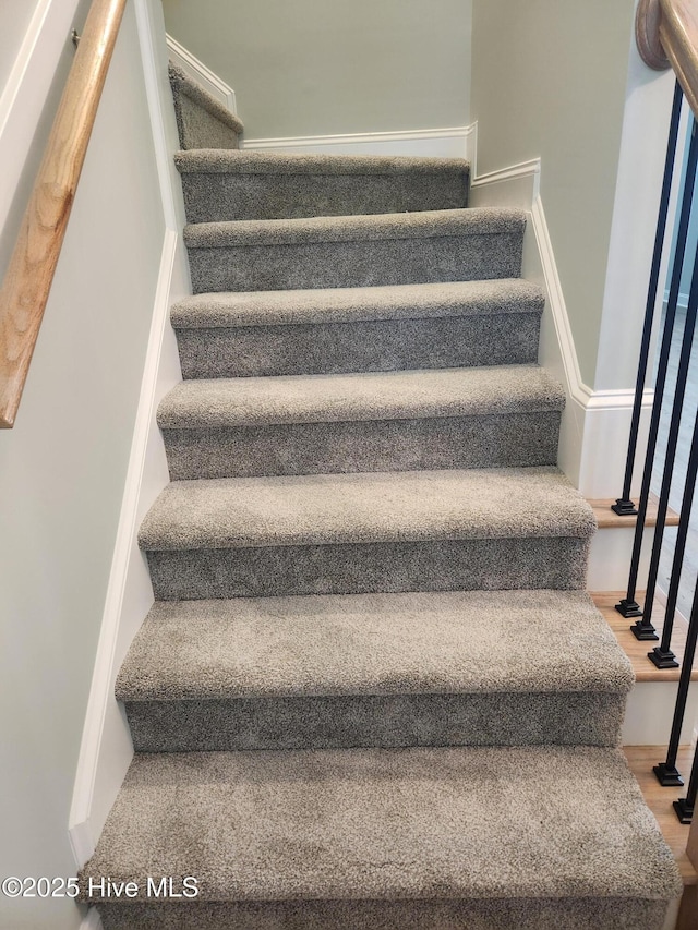 stairs featuring hardwood / wood-style flooring